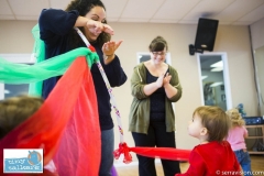 Toddlers participating in a play group aimed at reinforcing and teaching sign language to pre-verbal children