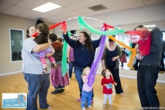 Toddlers participating in a play group aimed at reinforcing and teaching sign language to pre-verbal children